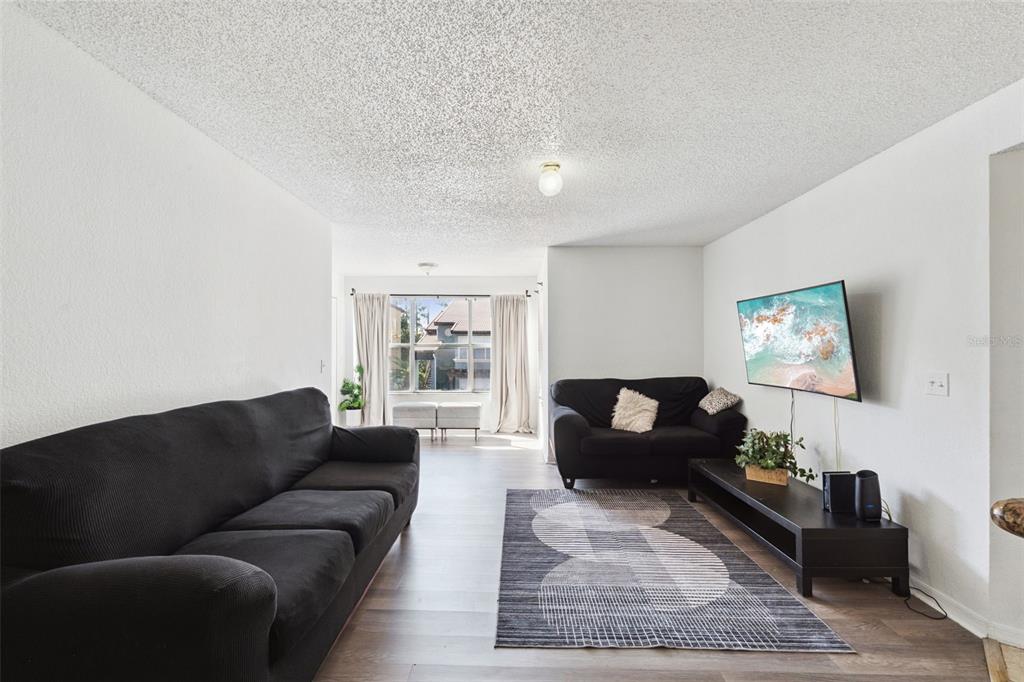 5120 Conroy Road, Unit 28 Orlando, FL 32811 - Photo 7 of 39 a living room with furniture and a couch