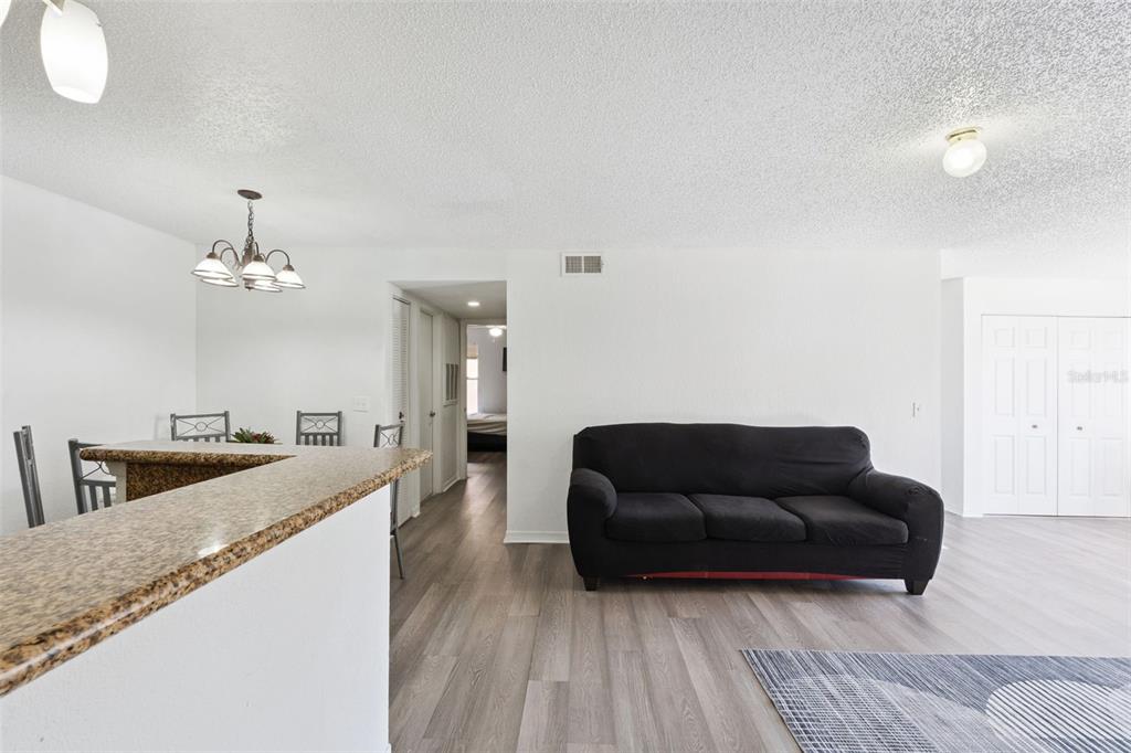 5120 Conroy Road, Unit 28 Orlando, FL 32811 - Photo 8 of 39 a living room with furniture and a chandelier