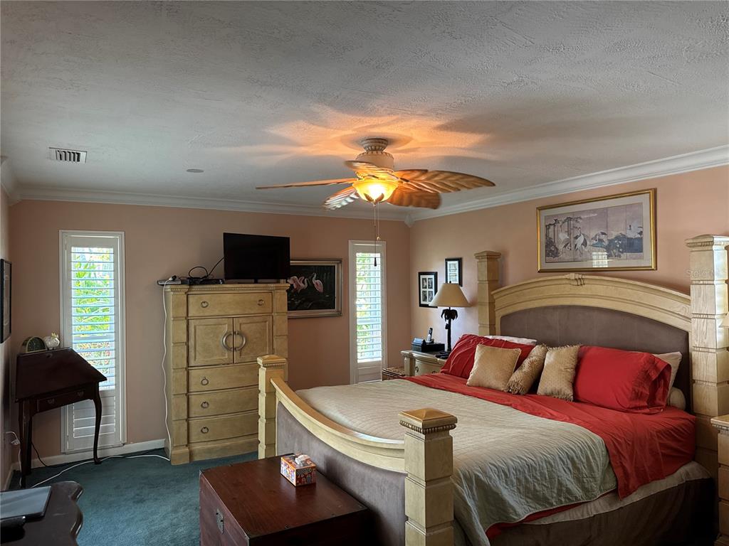 6319 Cocoa Lane Apollo Beach, FL 33572 - Photo 13 of 37 a bedroom with a bed and a chandelier