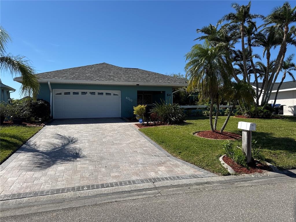 6319 Cocoa Lane Apollo Beach, FL 33572 - Photo 27 of 37 a front view of a house with a yard and garage