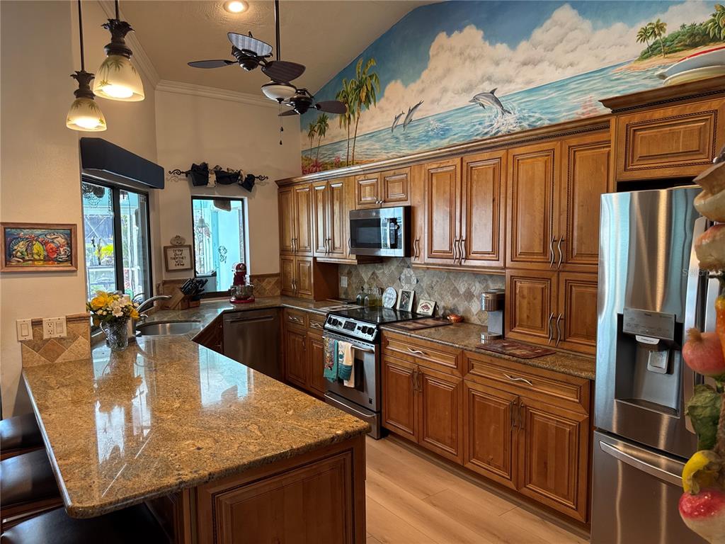 6319 Cocoa Lane Apollo Beach, FL 33572 - Photo 10 of 37 a kitchen with stainless steel appliances granite countertop a sink a stove and a refrigerator