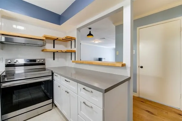 a kitchen with cabinets and appliances
