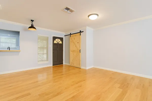 a view of an empty room with glass door