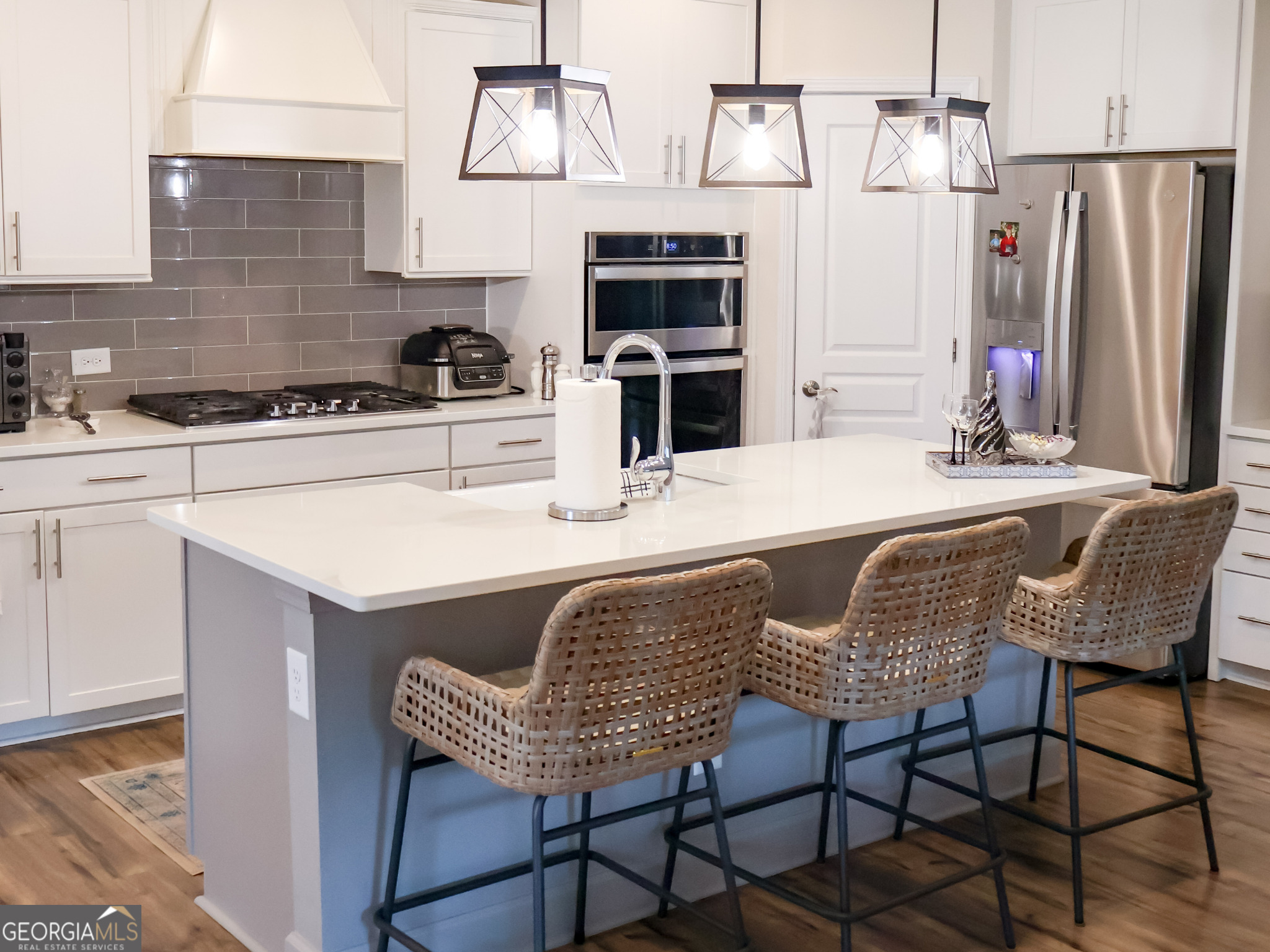218 Florence Road Peachtree City, GA 30269 - Photo 11 of 47 a kitchen with stainless steel appliances granite countertop a table chairs stove and refrigerator