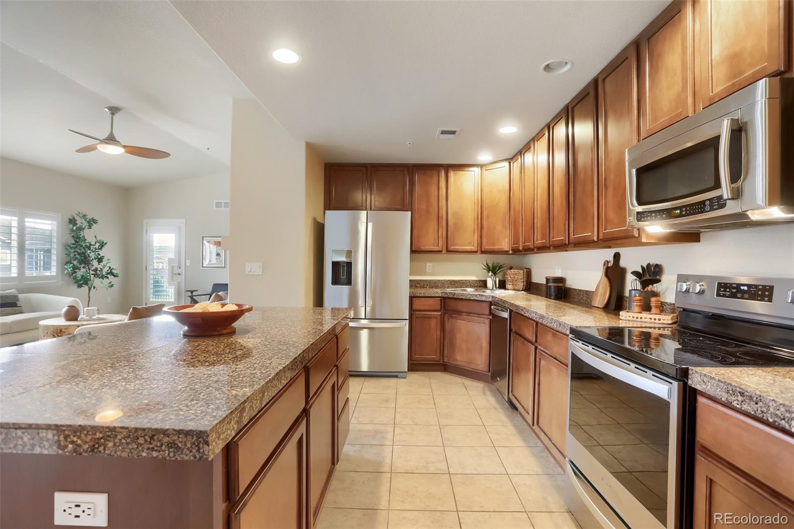 6232 Kilmer Loop, Unit 203 Golden, CO 80403 - Photo 12 of 33 a kitchen with stainless steel appliances granite countertop a sink a stove and a refrigerator