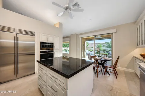 a kitchen with stainless steel appliances a stove and cabinets