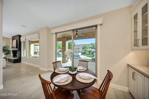 a kitchen with a table chairs and refrigerator