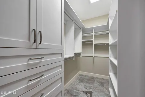 a bathroom with a granite countertop sink a mirror and shower