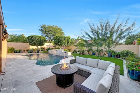 a bathroom with a granite countertop sink a mirror and shower