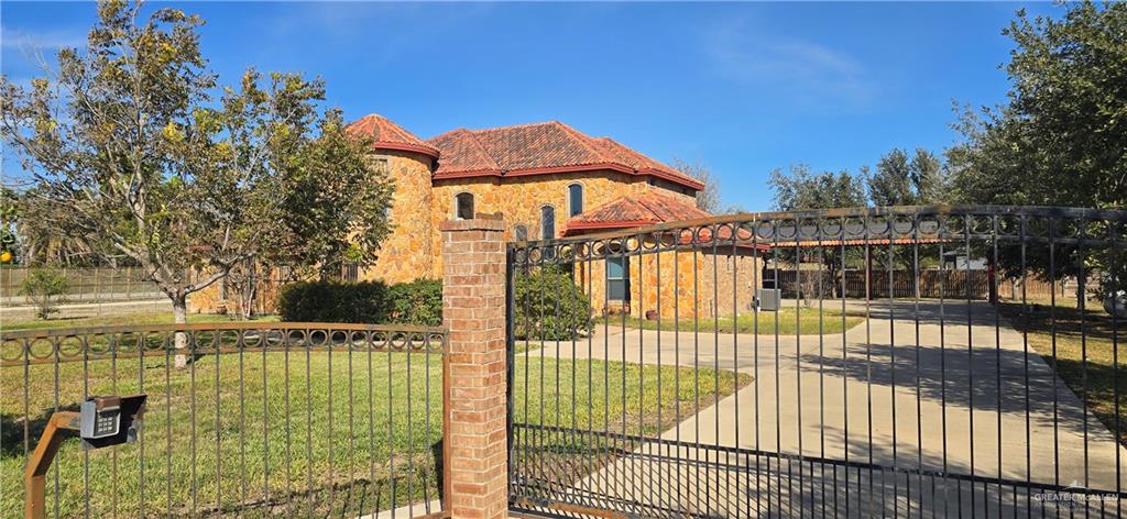 5312 Mile 4 Road Mission, TX 78573 - Photo 4 of 13 Gate featuring a fenced front yard and a patio