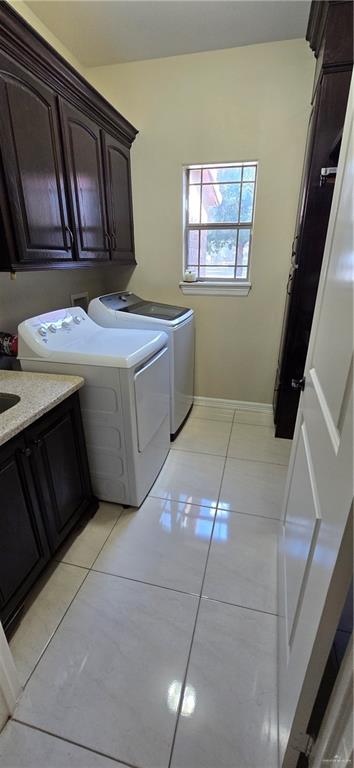 5312 Mile 4 Road Mission, TX 78573 - Photo 10 of 13 Laundry area with cabinet space, light tile patterned floors, and washing machine and dryer