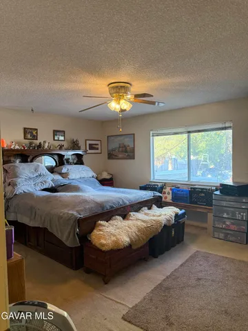 a bedroom with bed and window