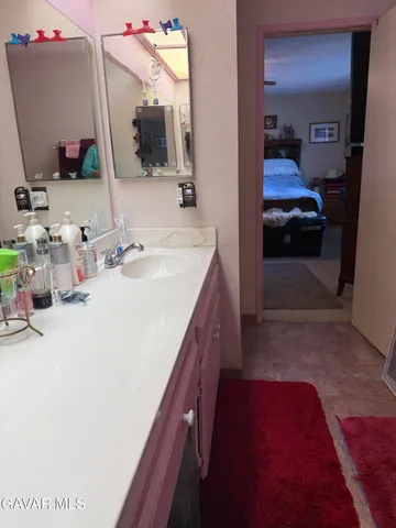 a en suite bathroom with a sink and a mirror