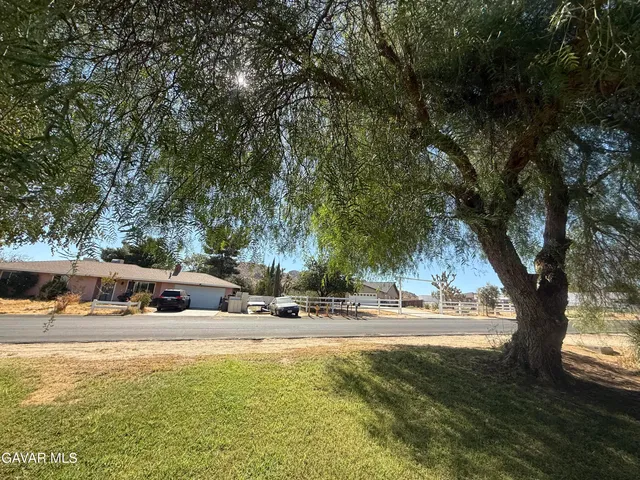 a swimming pool with outdoor seating and trees