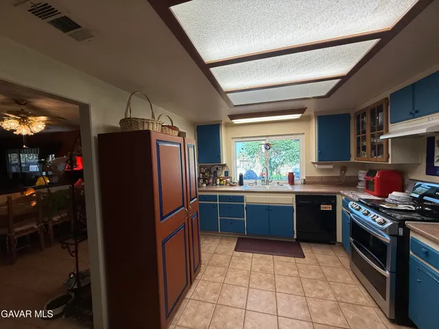 a kitchen with stainless steel appliances granite countertop a refrigerator stove and sink