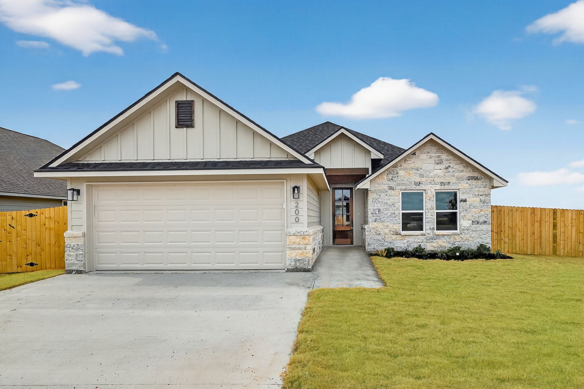 200 Orchard Cove Snook, TX 77879 - Photo 1 of 45 a front view of a house with a yard and garage
