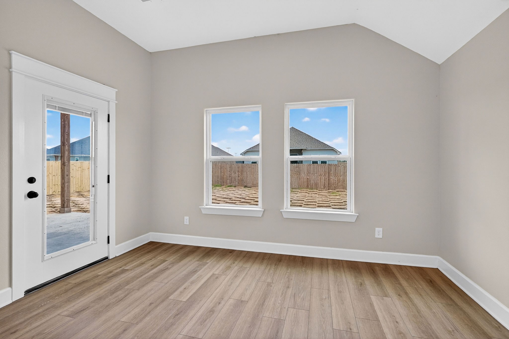 200 Orchard Cove Snook, TX 77879 - Photo 12 of 45 an empty room with wooden floor and windows