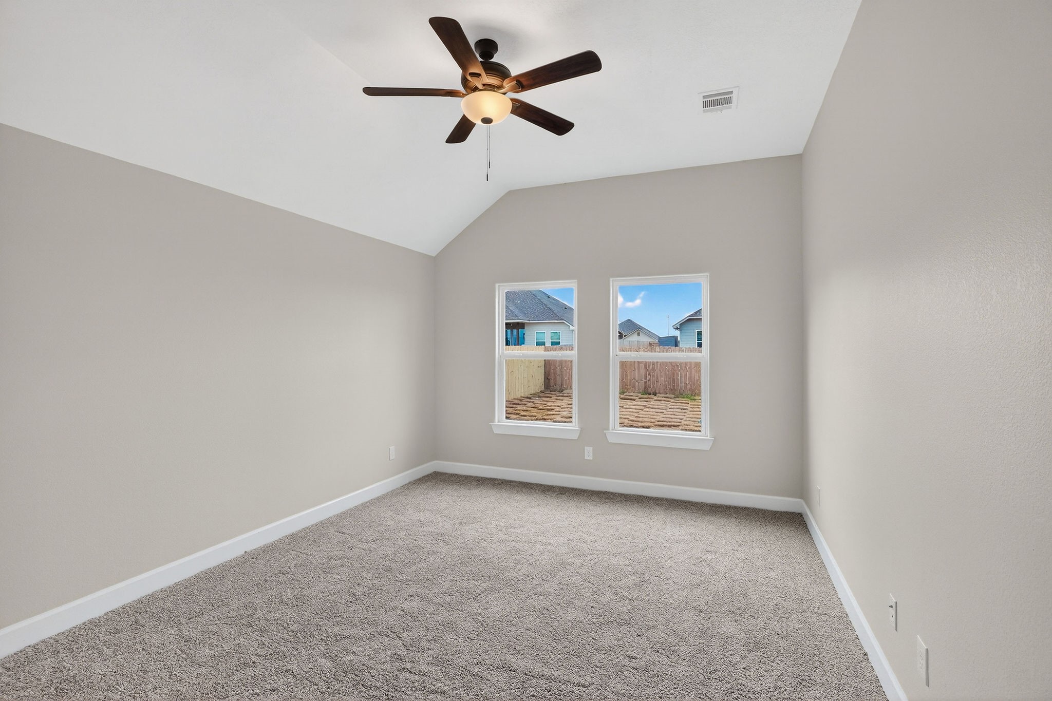 200 Orchard Cove Snook, TX 77879 - Photo 14 of 45 an empty room with chandelier fan and windows