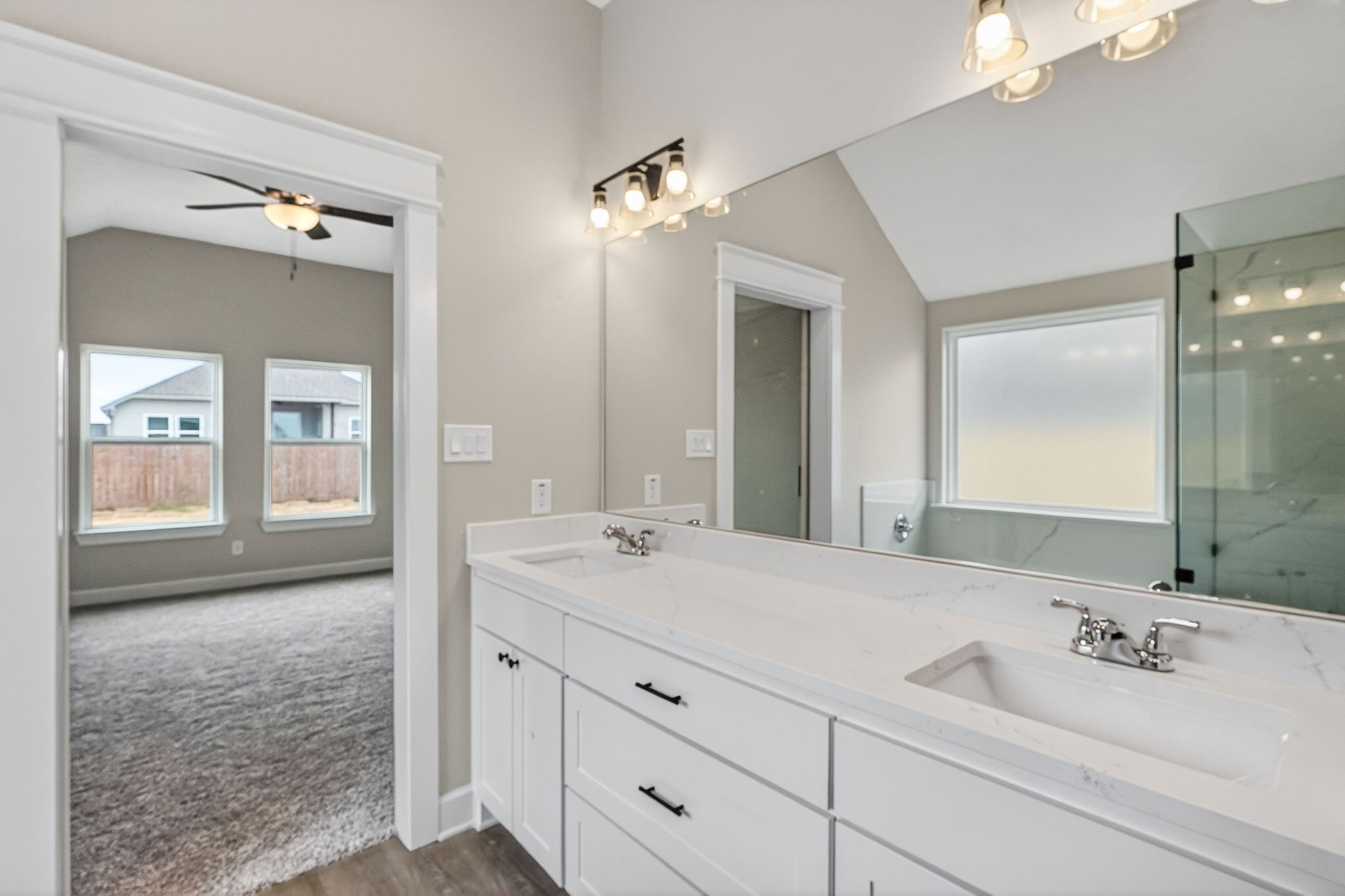 200 Orchard Cove Snook, TX 77879 - Photo 19 of 45 a en suite bathroom with double sink and a mirror