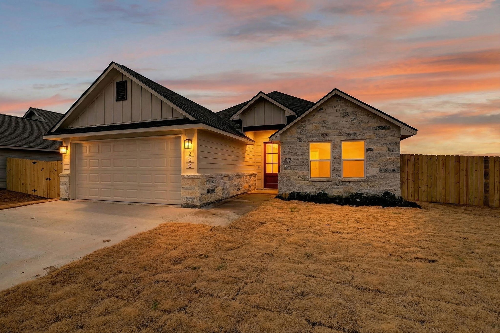 200 Orchard Cove Snook, TX 77879 - Photo 42 of 45 a front view of a house with a yard and garage