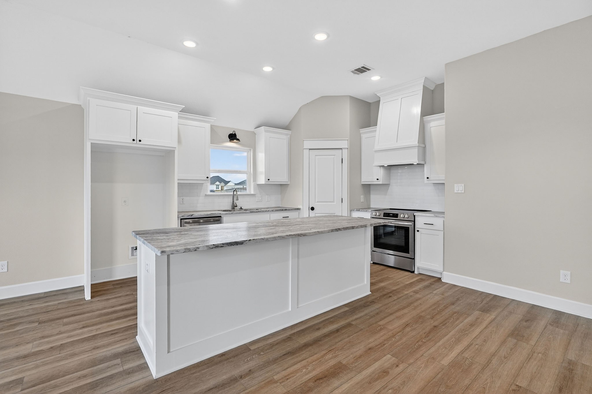 200 Orchard Cove Snook, TX 77879 - Photo 8 of 45 a kitchen with stainless steel appliances a sink stove and wooden floor
