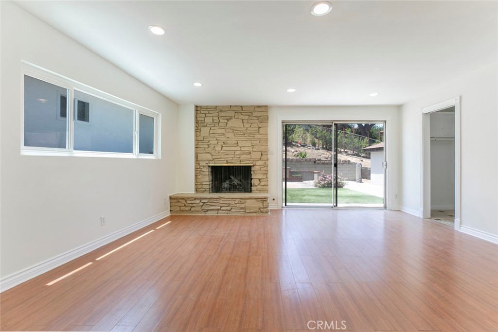10347 Newhome Avenue Sunland, CA 91040 - Photo 11 of 33 a view of empty room with wooden floor and fireplace