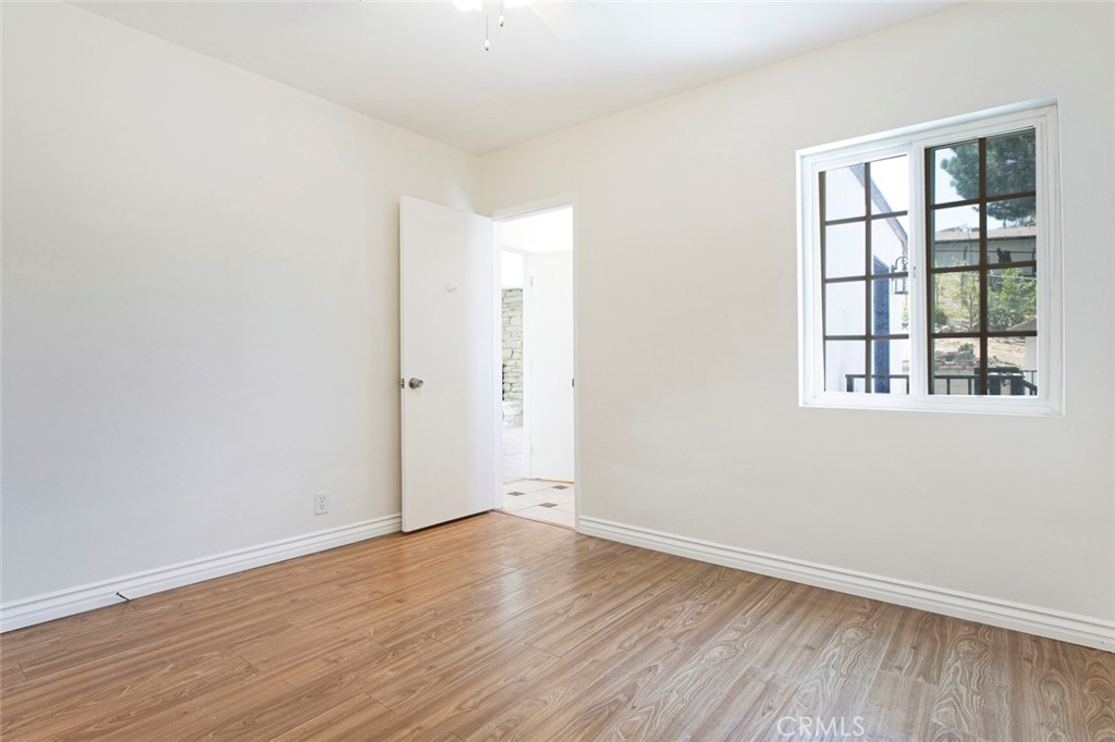 10347 Newhome Avenue Sunland, CA 91040 - Photo 19 of 33 an empty room with wooden floor and windows