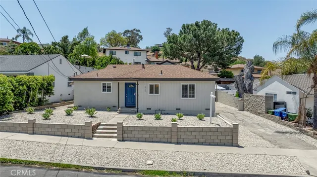 a front view of a house with lots of green space