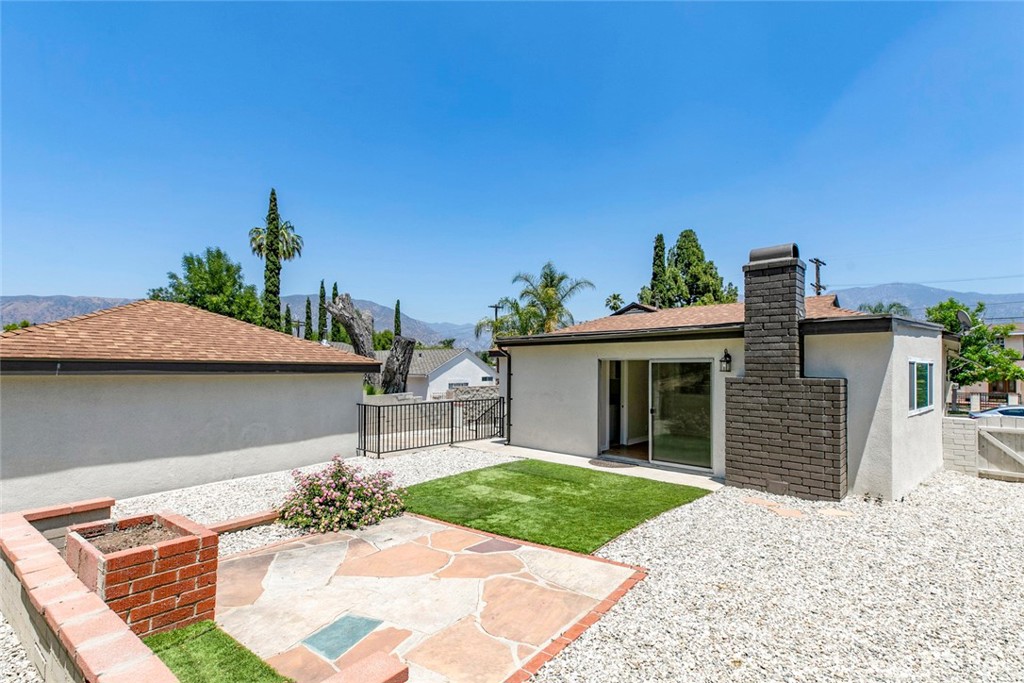 10347 Newhome Avenue Sunland, CA 91040 - Photo 25 of 33 a front view of a house with a garden and yard