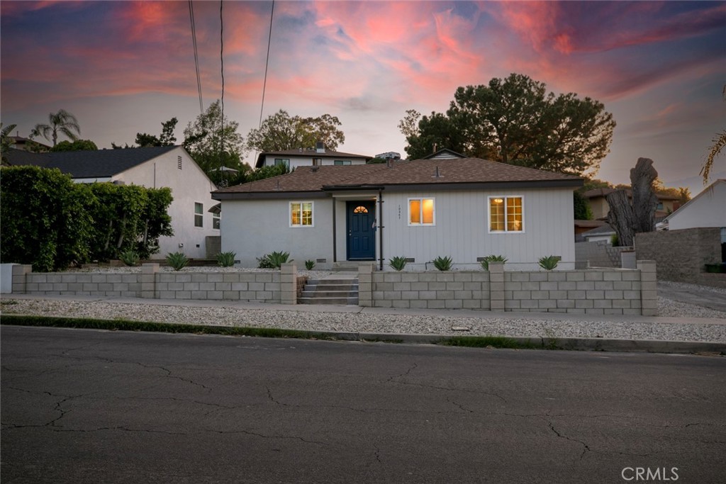 10347 Newhome Avenue Sunland, CA 91040 - Photo 29 of 33 a front view of a house with a yard and garage