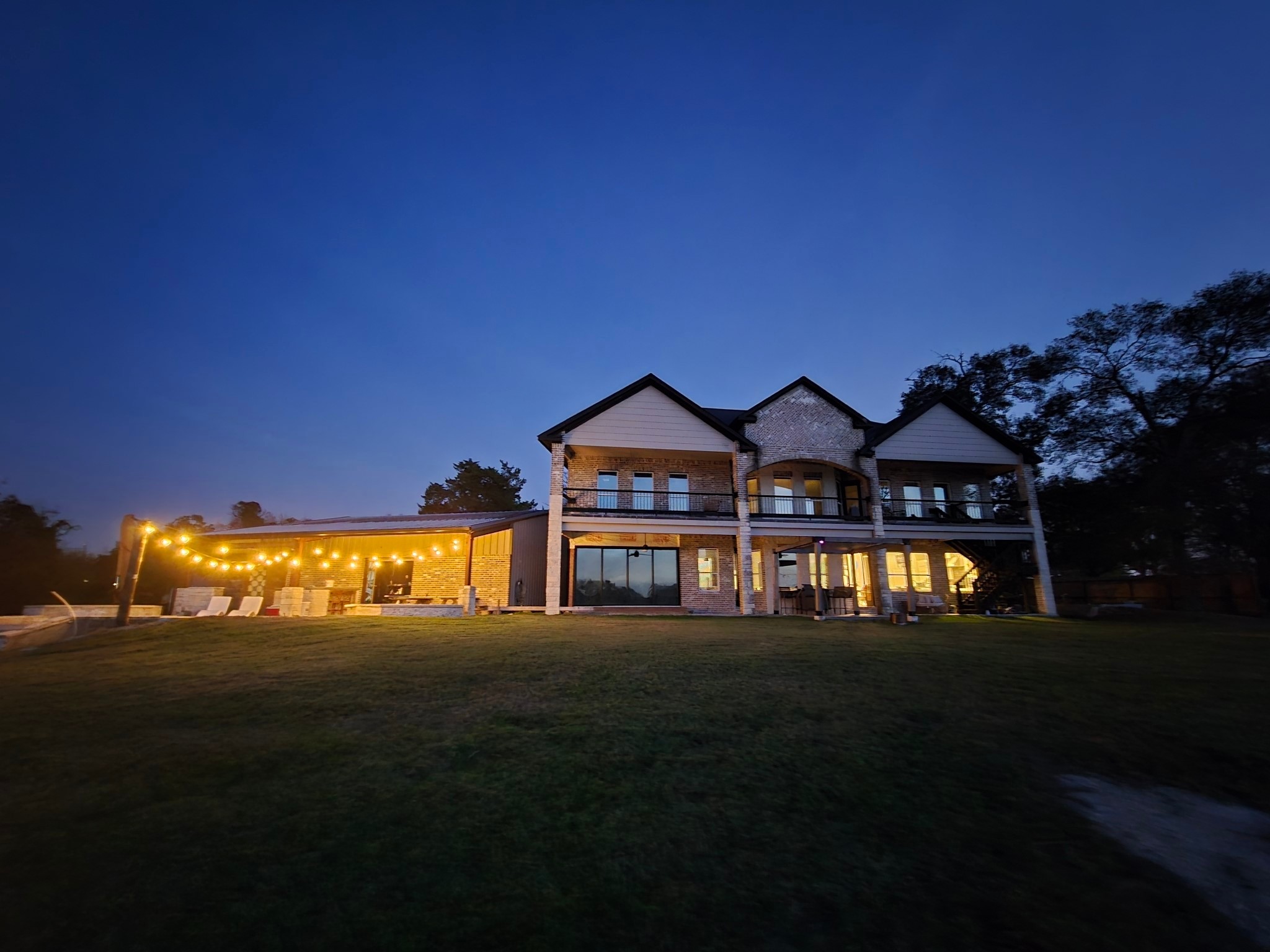 a view of a big house with a big yard