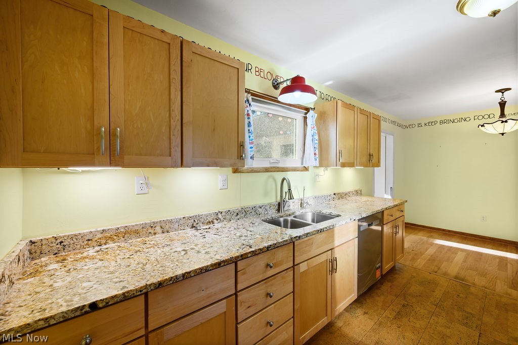 11363 Dupont Road Washington, WV 26181 - Photo 10 of 42 Kitchen featuring wood cabinetry, light-toned countertops, a stainless steel double sink with a high-arc faucet, and wood-finish flooring