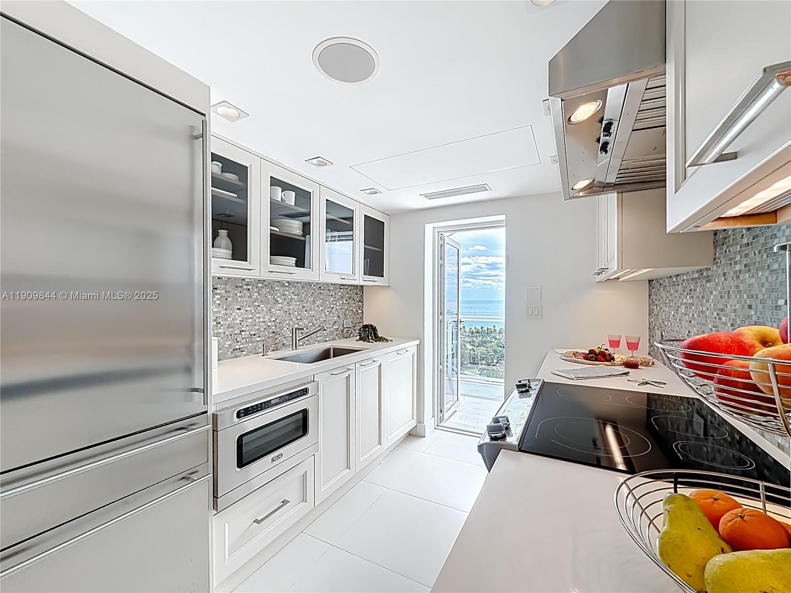 2715 North Ocean Boulevard, Unit 15D Fort Lauderdale, FL 33308 - Photo 13 of 57 a kitchen with stainless steel appliances granite countertop a stove and a sink