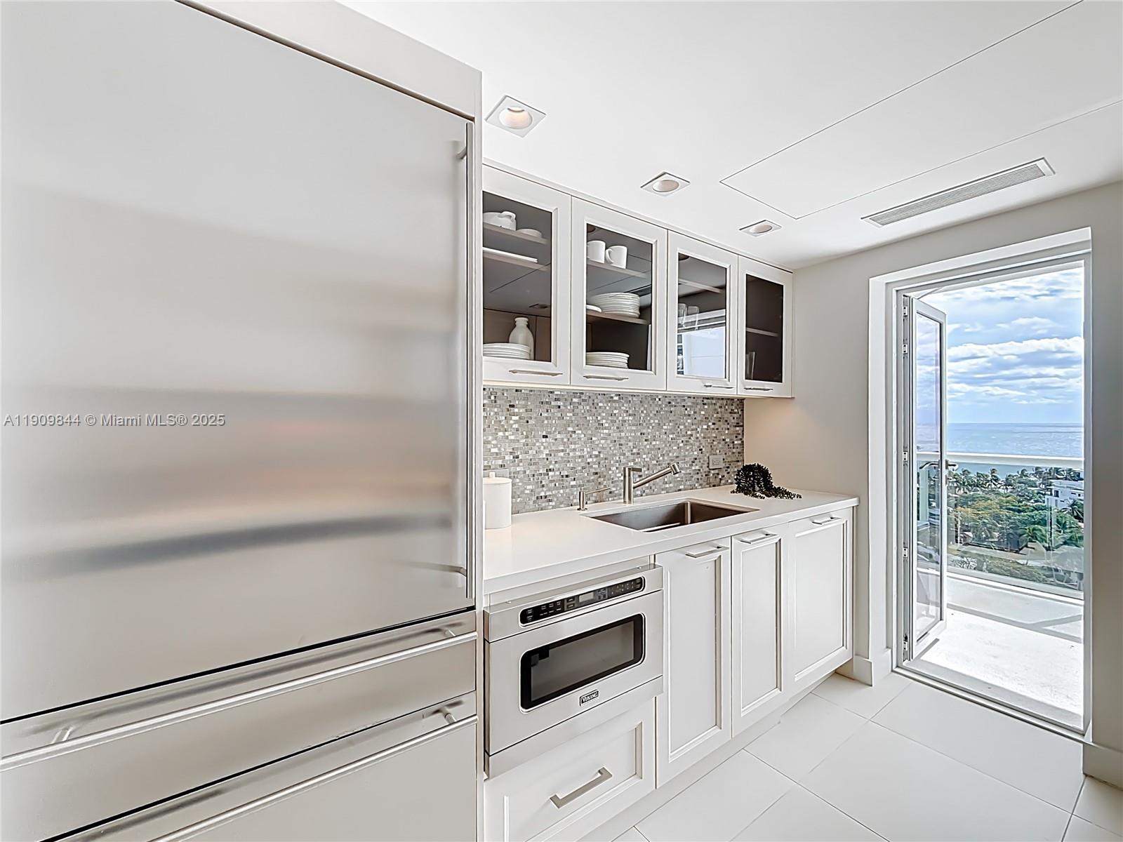 2715 North Ocean Boulevard, Unit 15D Fort Lauderdale, FL 33308 - Photo 14 of 57 a kitchen with a stove and a refrigerator