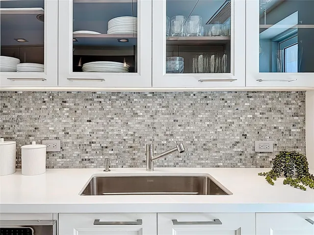 a kitchen with a sink and large cabinets