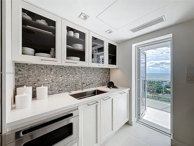 a kitchen with a sink stove and cabinets