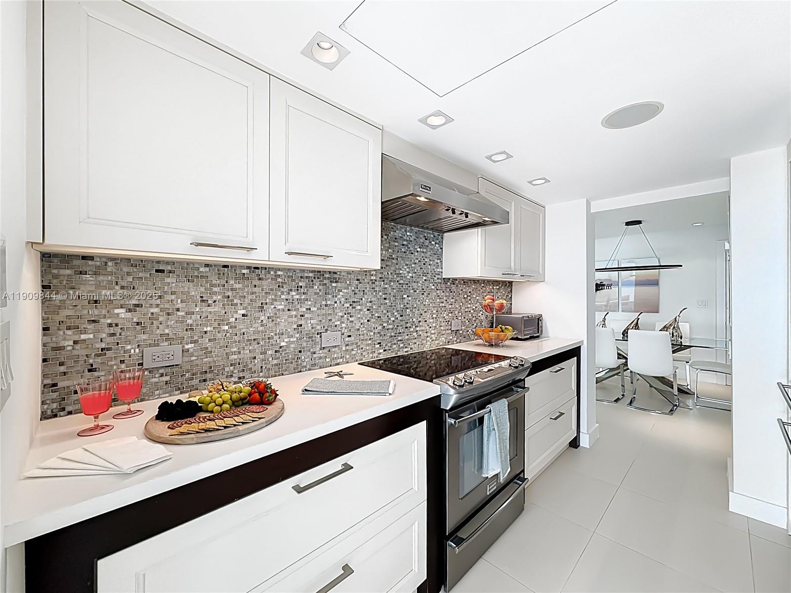 2715 North Ocean Boulevard, Unit 15D Fort Lauderdale, FL 33308 - Photo 20 of 57 a kitchen with a sink stove and cabinets
