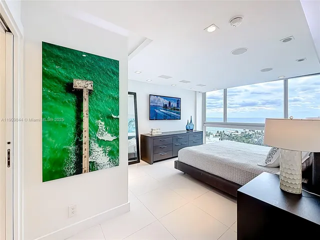 a living room with a bed furniture and large window