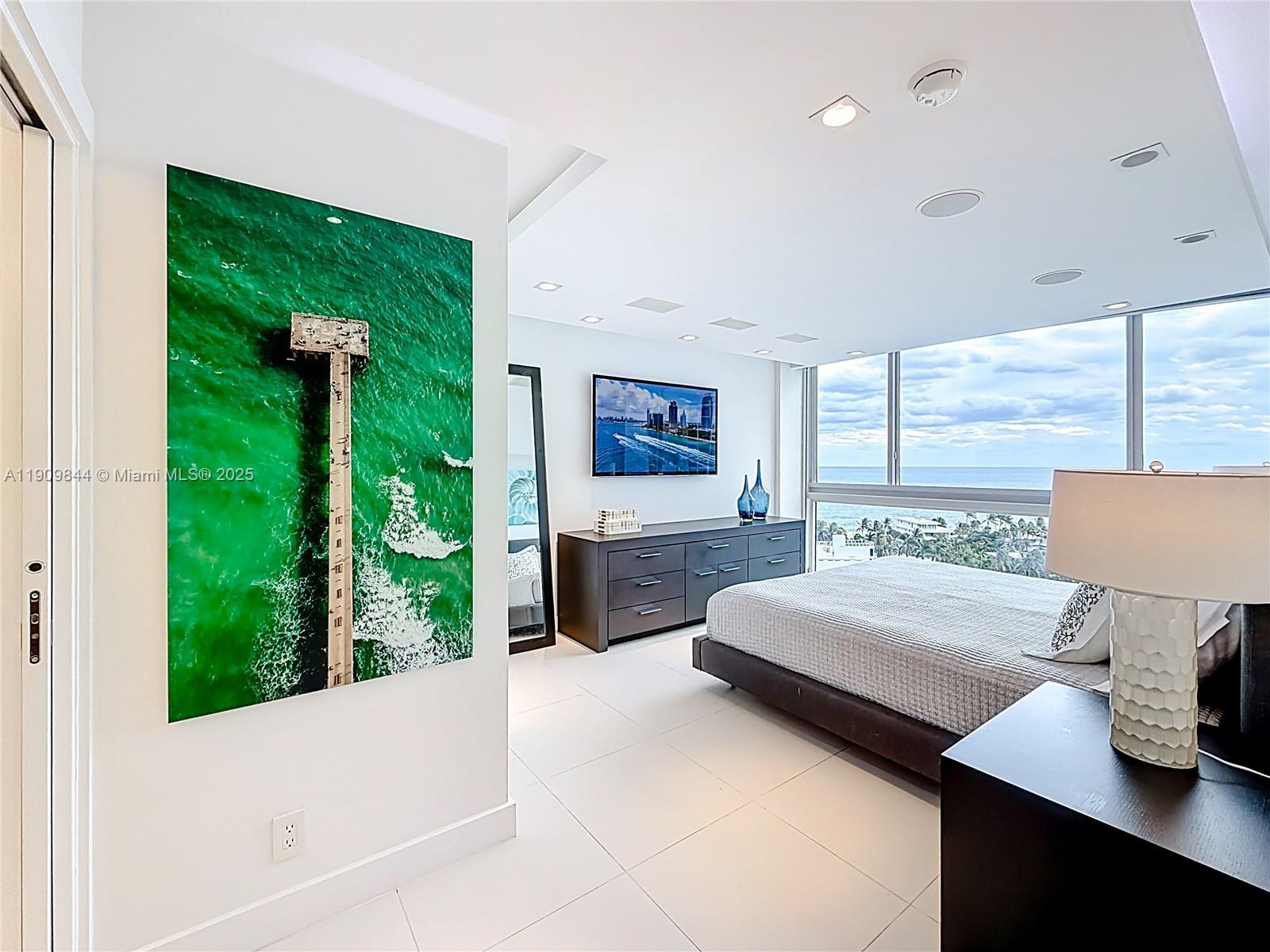 2715 North Ocean Boulevard, Unit 15D Fort Lauderdale, FL 33308 - Photo 21 of 57 a spacious bedroom with a bed and a large window