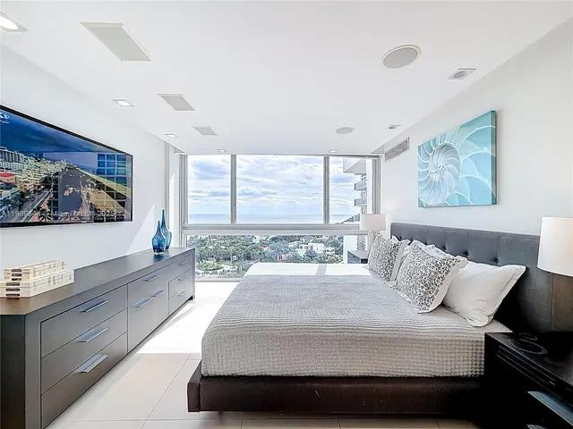 a bedroom with a bed and a night stand