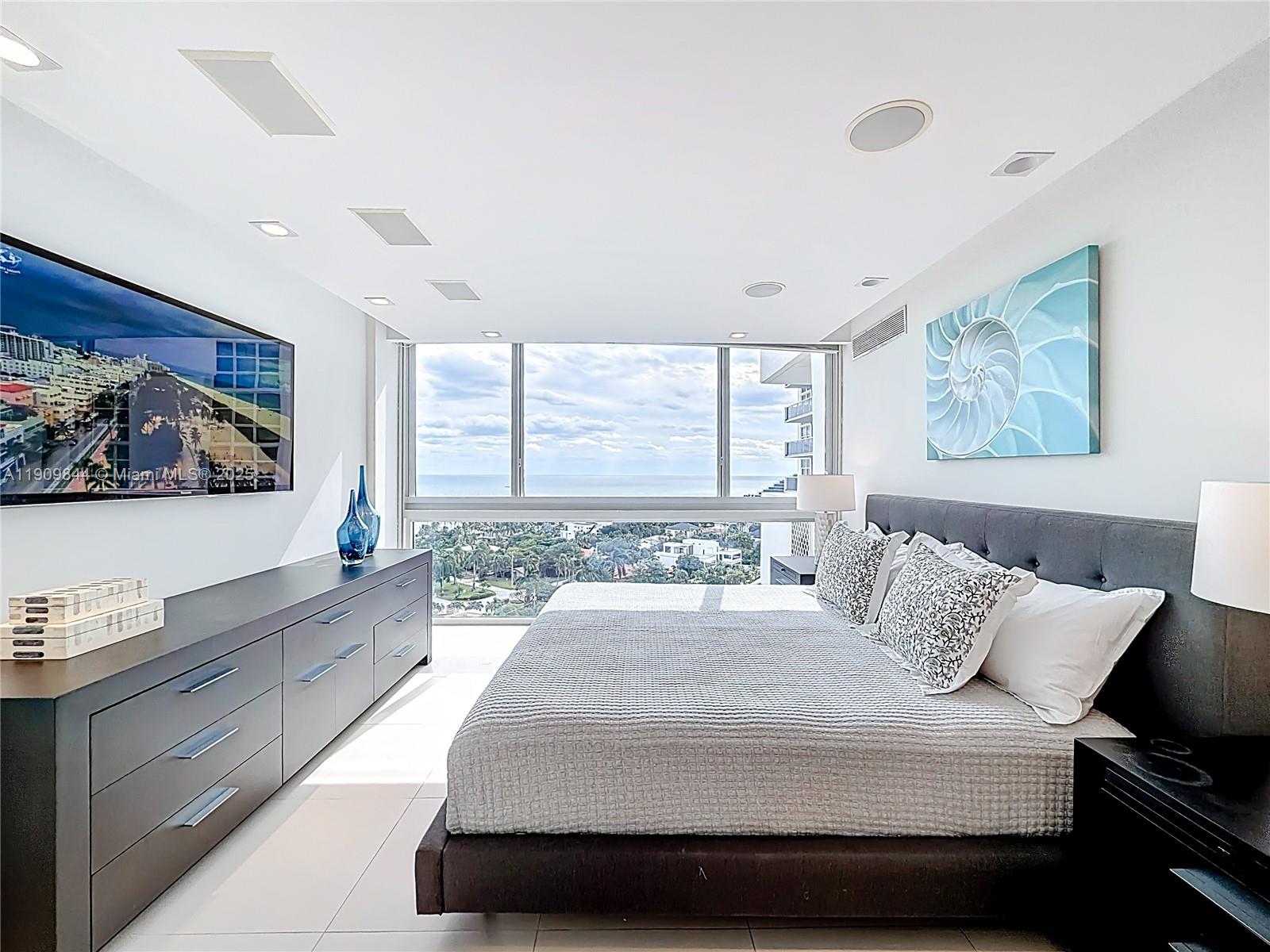 2715 North Ocean Boulevard, Unit 15D Fort Lauderdale, FL 33308 - Photo 23 of 57 a bedroom with a large bed and a large window
