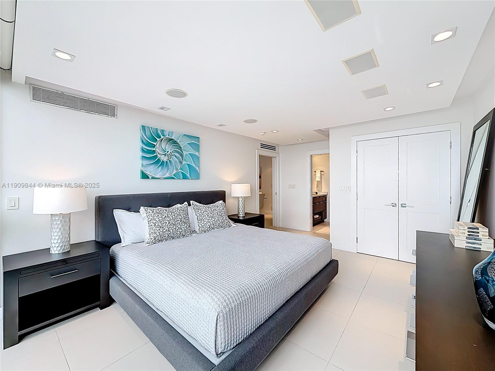 2715 North Ocean Boulevard, Unit 15D Fort Lauderdale, FL 33308 - Photo 24 of 57 a bedroom with a bed and a night stand