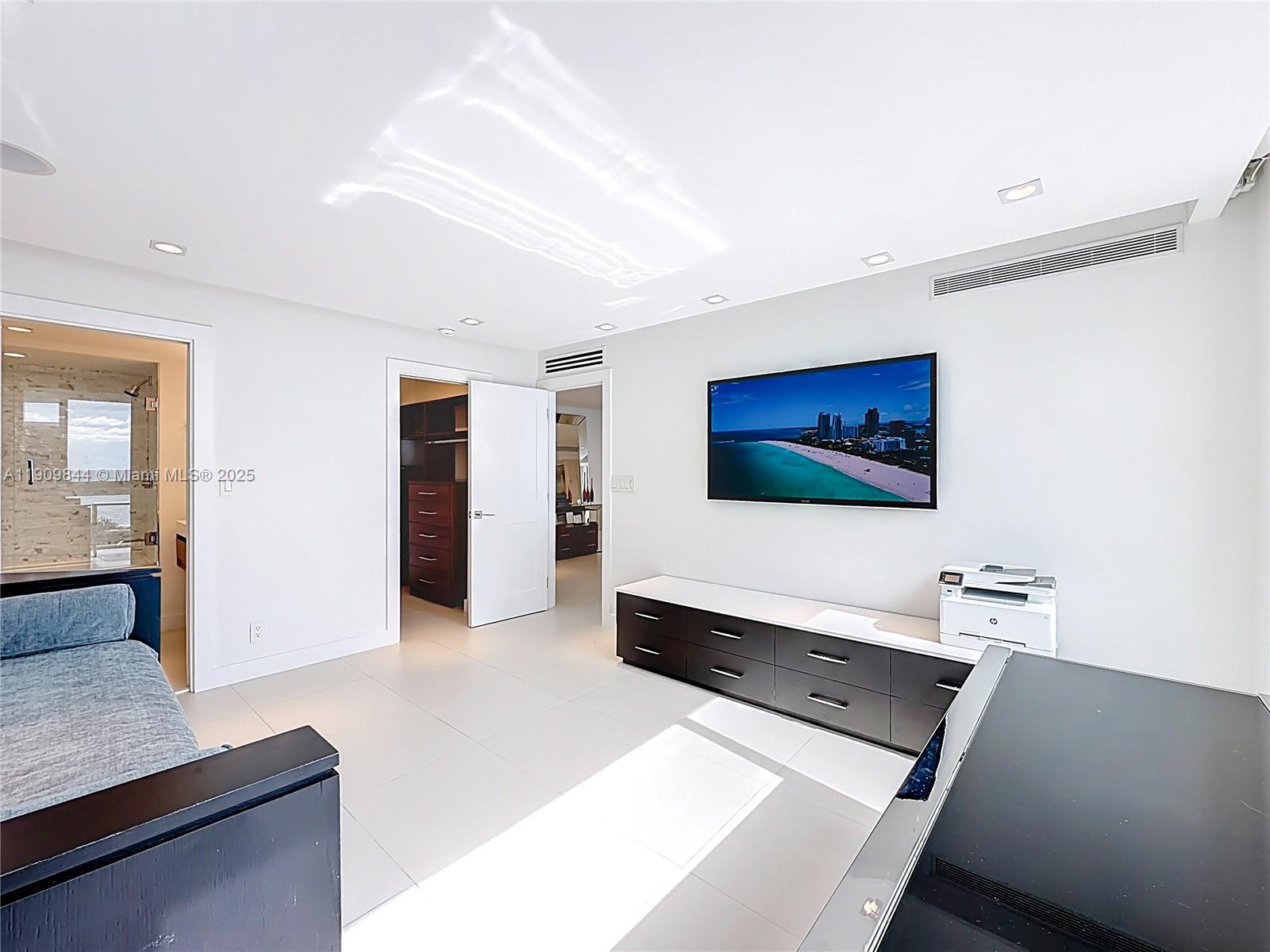 2715 North Ocean Boulevard, Unit 15D Fort Lauderdale, FL 33308 - Photo 33 of 57 a living room with furniture and a flat screen tv