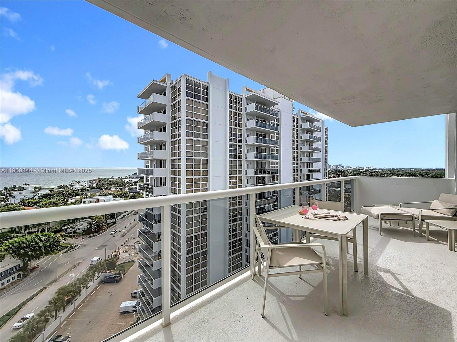 2715 North Ocean Boulevard, Unit 15D Fort Lauderdale, FL 33308 - Photo 39 of 57 a balcony with a table and chairs and a stove