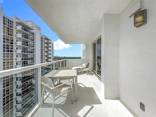 a view of a balcony dining table and chairs