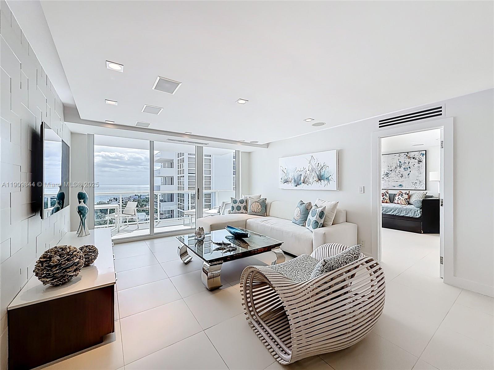 2715 North Ocean Boulevard, Unit 15D Fort Lauderdale, FL 33308 - Photo 5 of 57 a living room with furniture and a flat screen tv
