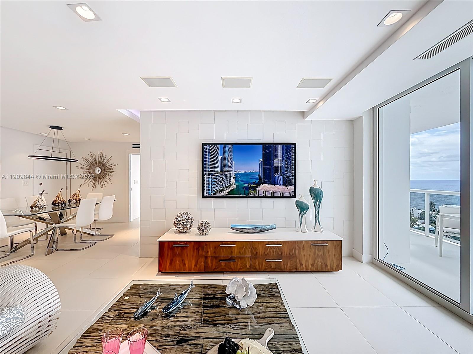 2715 North Ocean Boulevard, Unit 15D Fort Lauderdale, FL 33308 - Photo 8 of 57 a living room with furniture and a flat screen tv