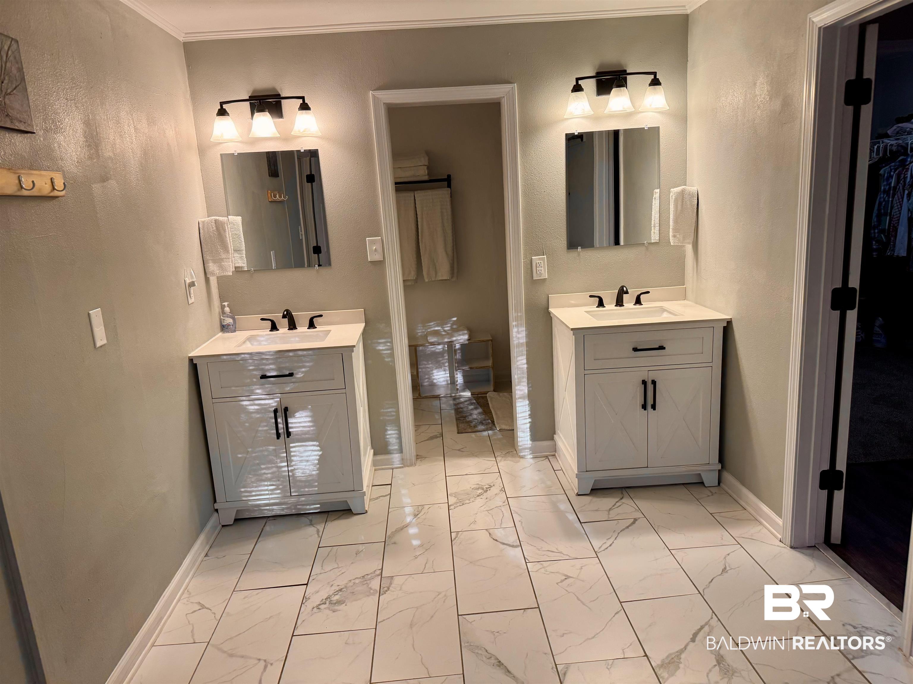 1302 Oak Street Daphne, AL 36526 - Photo 15 of 34 Bathroom with light marble finish floors, two vanities, and ornamental molding