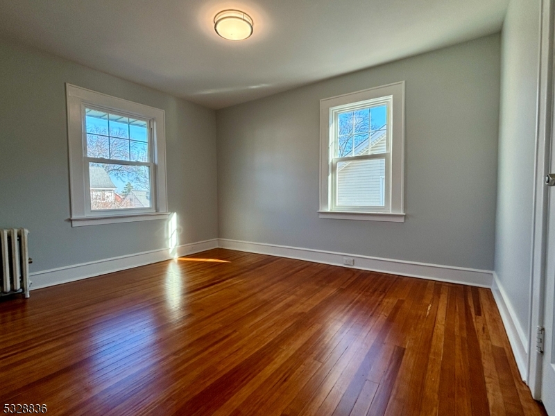 89 Hay Avenue Nutley, NJ 07110 - Photo 14 of 24 a view of an empty room with wooden floor and a window
