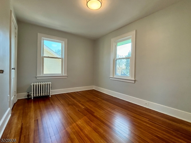 89 Hay Avenue Nutley, NJ 07110 - Photo 15 of 24 a view of empty room with wooden floor and fan